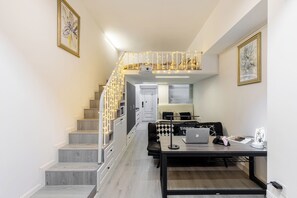 Un interior moderno con una escalera, un comedor y un espacio de trabajo.