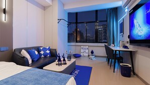 A modern hotel room with a bed, a desk, a chair, a TV, and a window with a city view. - ShanghaiHills&SunflowerUltraHorizonHotel (Shanghai)