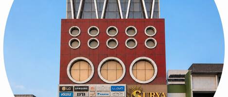 A building with multiple commercial signs, including LG and Surya Regency.