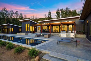 A modern house with a pool, outdoor seating, and a barbecue area. - Lap Pool + Sauna + Outdoor Kitchen | 40 Acres, Glen Ellen | Olive & Oak (Glen Ellen)