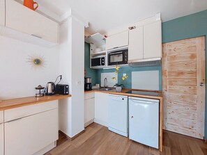 A compact kitchen with white cabinets, a microwave, a coffee maker, and a toaster. - Les Lavandes by Interhome (Saint Cyr sur mer Les Lecques)