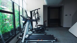 A home gym with exercise equipment including a treadmill, stationary bike, and weight machines. - 6500 Hotel Chaozong Street Wuyi Plaza (Changsha)