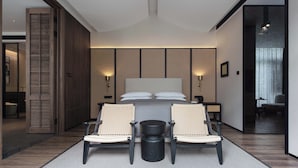 A modern bedroom with a large bed, two chairs, a small table, and a nightstand. - 6500 Hotel Chaozong Street Wuyi Plaza (Changsha)