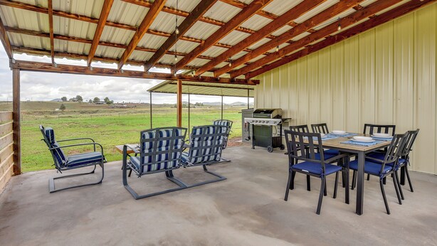 An outdoor patio with a table and chairs, a grill, and a view of the countryside. - Tranquil Wine Country Getaway w/ Hillside Views (Elgin)