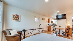 A hotel room with a bed, a chair, a small table, a TV, and a kitchenette. - Tranquil Wine Country Getaway w/ Hillside Views (Elgin)