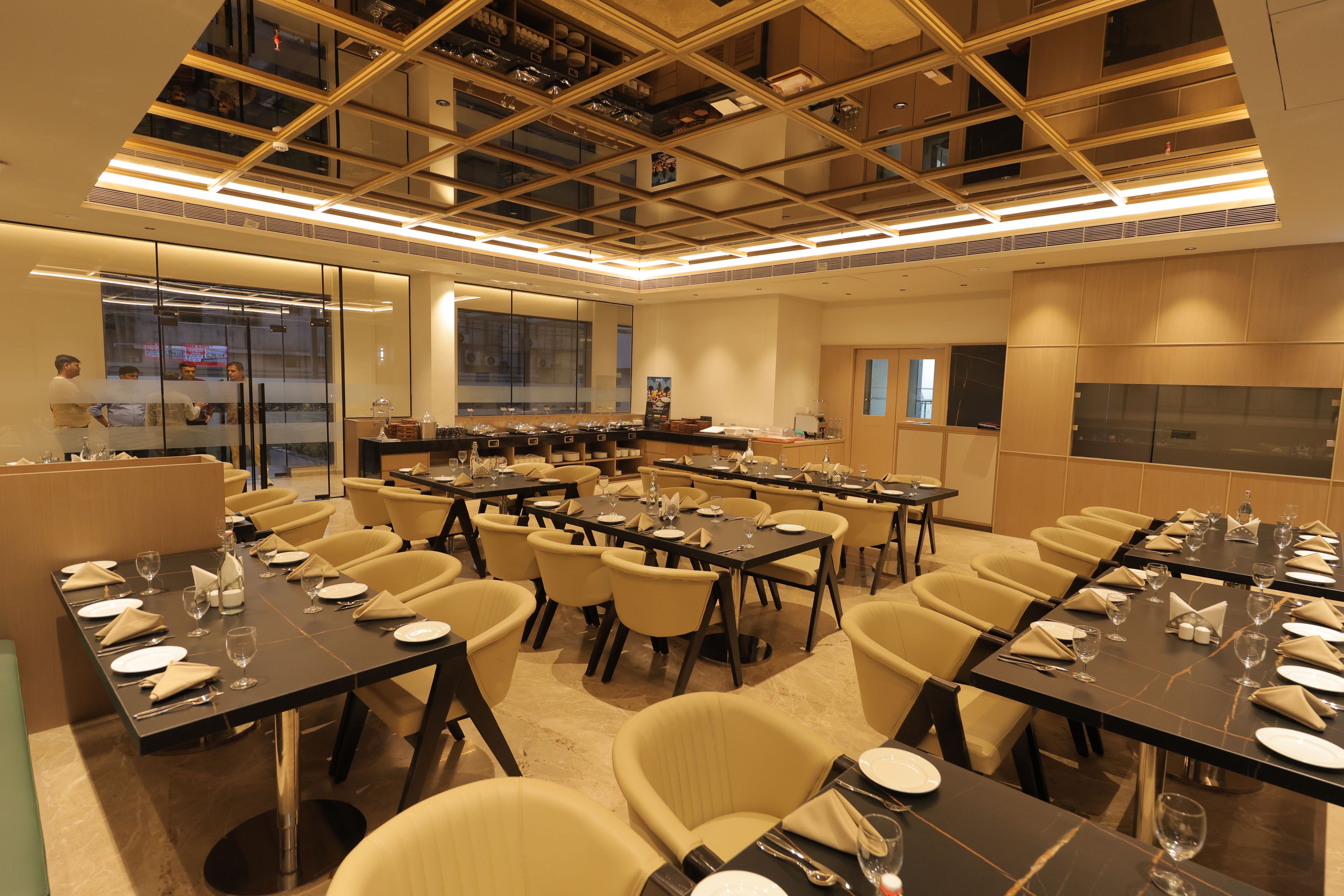 A conference room with multiple tables set for dining, equipped with chairs and table settings.