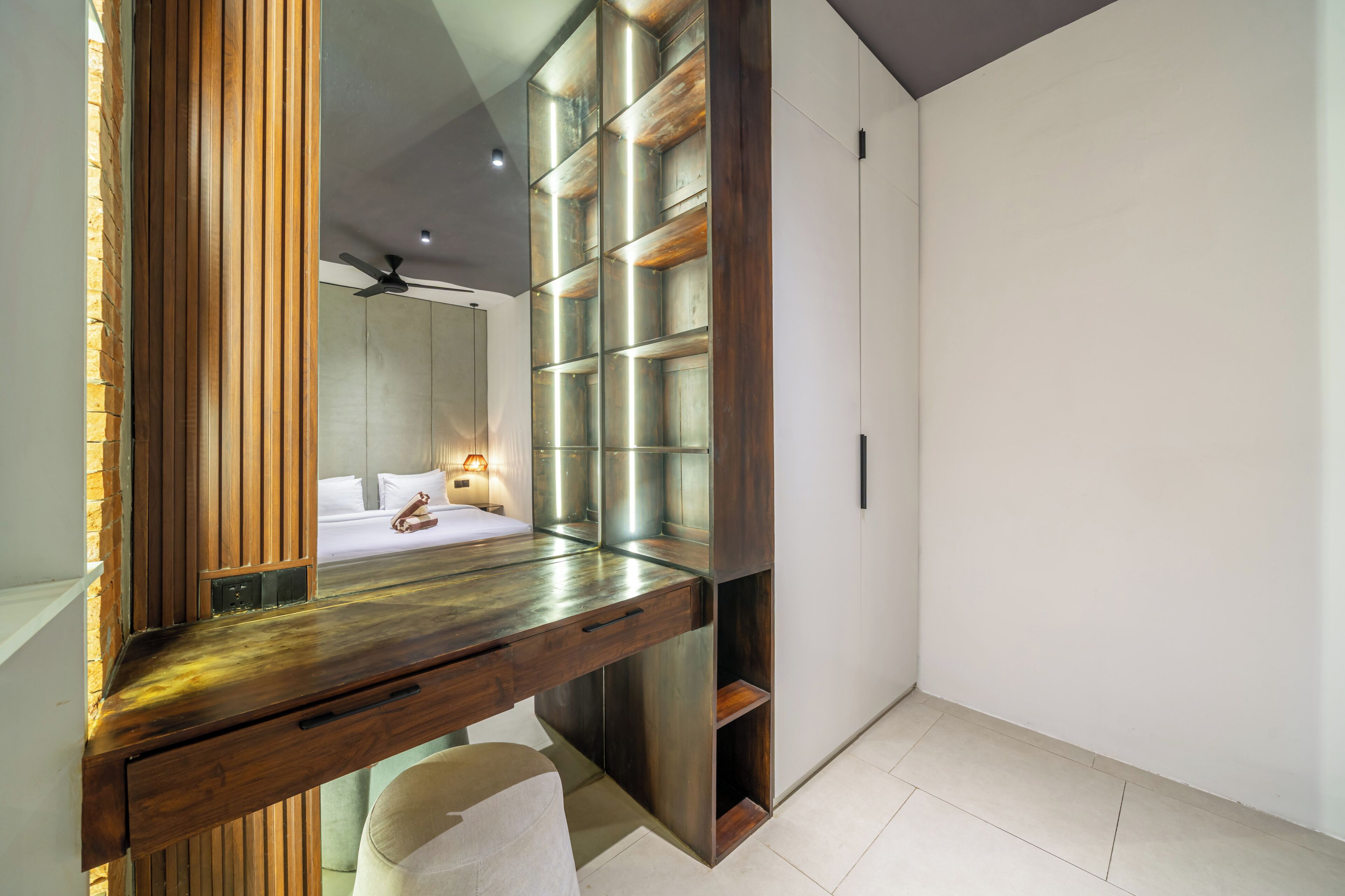 A modern bathroom with a wooden vanity, a large mirror, and a built-in shower area.