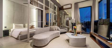 A modern living room with a sofa, a coffee table, and a TV.
