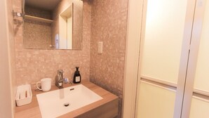 A bathroom with a white sink, a mirror, a white mug, a bottle, and a shower curtain. - HOTEL MELNA HAKATA (Fukuoka City)