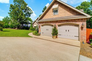 A two-story house with a garage, a covered porch, and a well-maintained lawn. - Hikes, Tee Times & Lake Days! Bella Vista Getaway (Bella Vista)