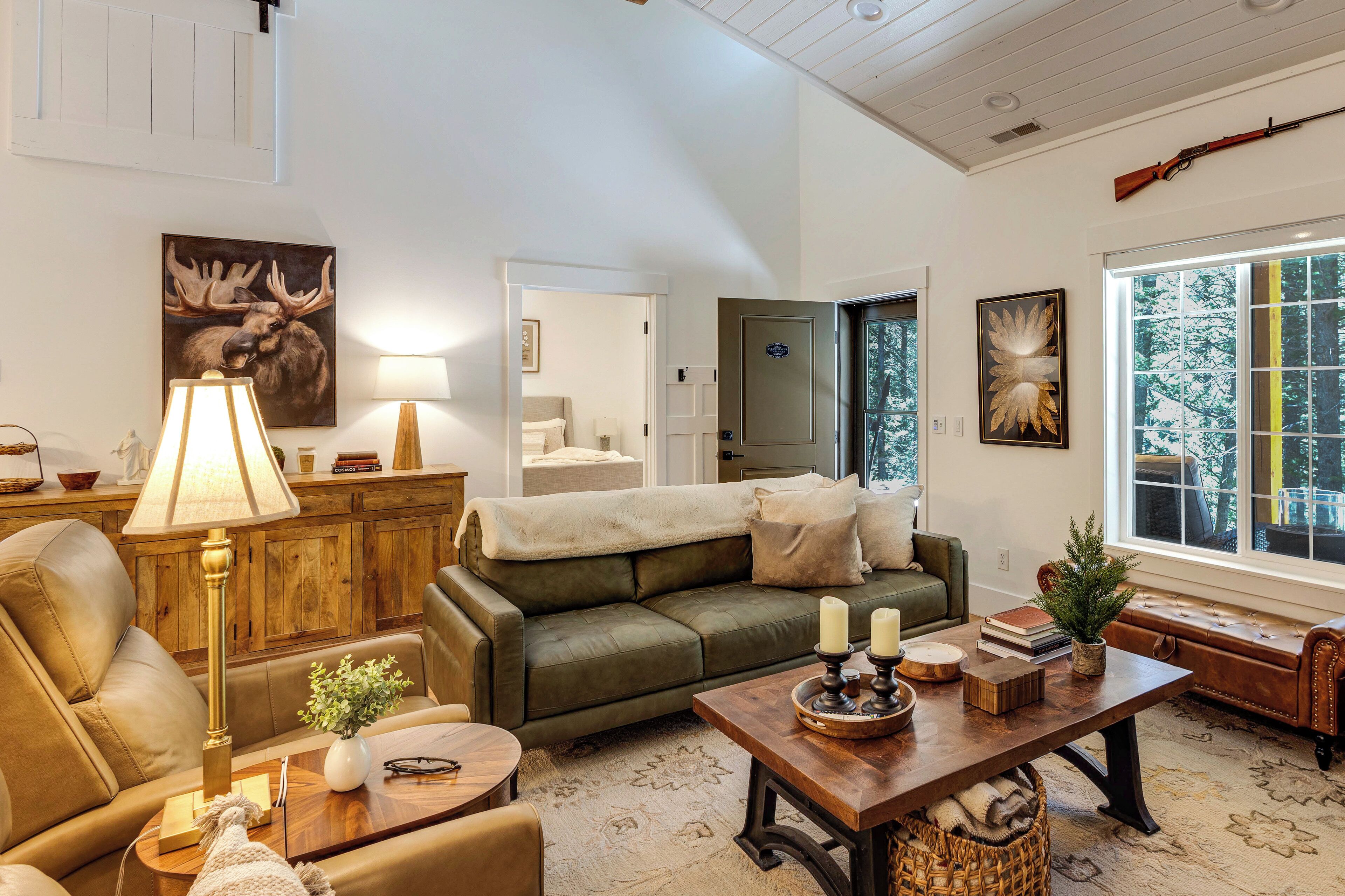 A cozy living room with a green sofa, a wooden coffee table, and a lamp.
