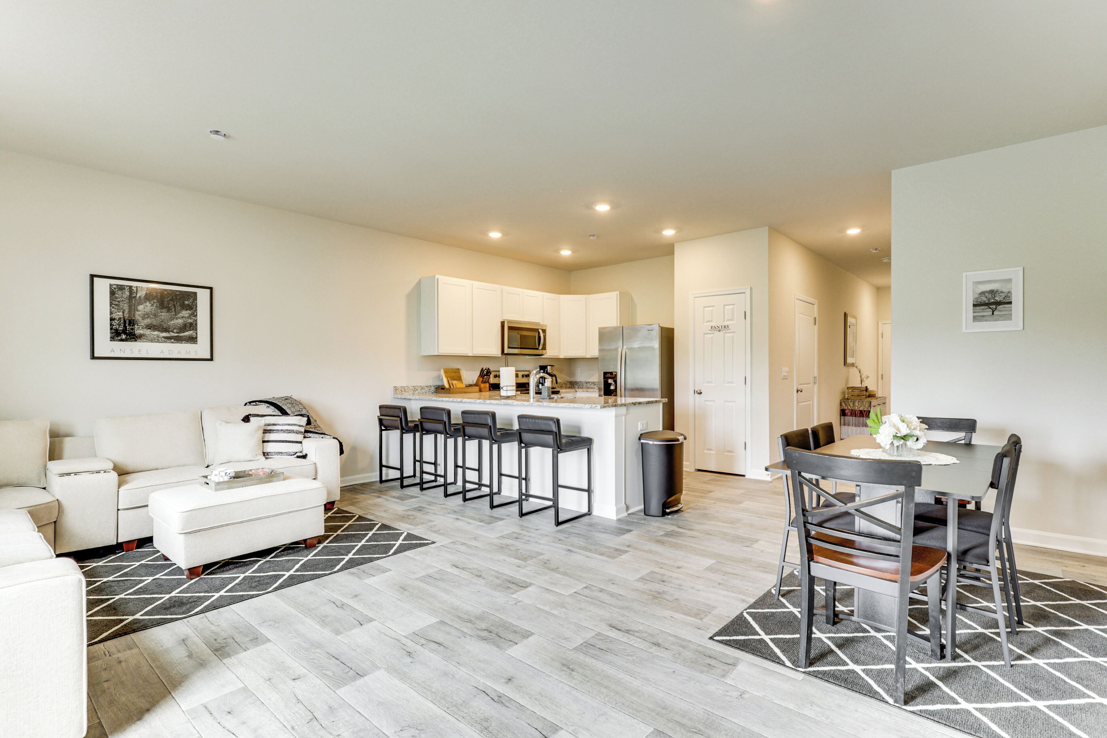 A modern apartment with a living room, kitchen, and dining area.