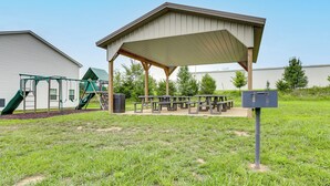 A covered picnic area with benches and a playground with a slide. - Monthly Stay-Beautiful Townhouse-Luray Attractions (Luray)