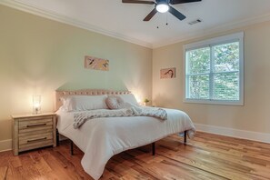 A bedroom with a bed, nightstands, a ceiling fan, and a window with blinds. - Helen Family Home w/ Innsbruck Resort Perks! (Helen)