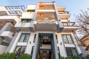A modern multi-story building with balconies, large windows, and a central entrance with a chandelier. - Sreng Angkor Hotel (Krong Siem Reap)