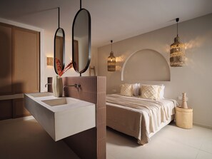 A modern bedroom with a large bed, a built-in vanity, and two pendant lights. - Luxury 6-bedroom villa in north Zakynthos | Private pool & sea views (Korithi)
