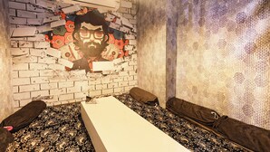 A room with a brick wall, a white table, and a patterned curtain. - Fabhotel Ssd Grand (Visakhapatnam)