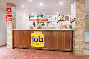 A reception desk with a 'fab hotels' sign, a 'no smoking' sign, and a 'reception' sign. - FabHotel Manvin's Inn (Panaji)