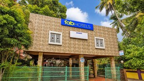 A hotel with a sign reading 'fab hotels' and a location sign 'CALANGUTE'.