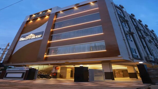 A modern hotel building with a prominent sign for 'Hotel Grand.' - Fabhotel Swagath Grand (Khammam)