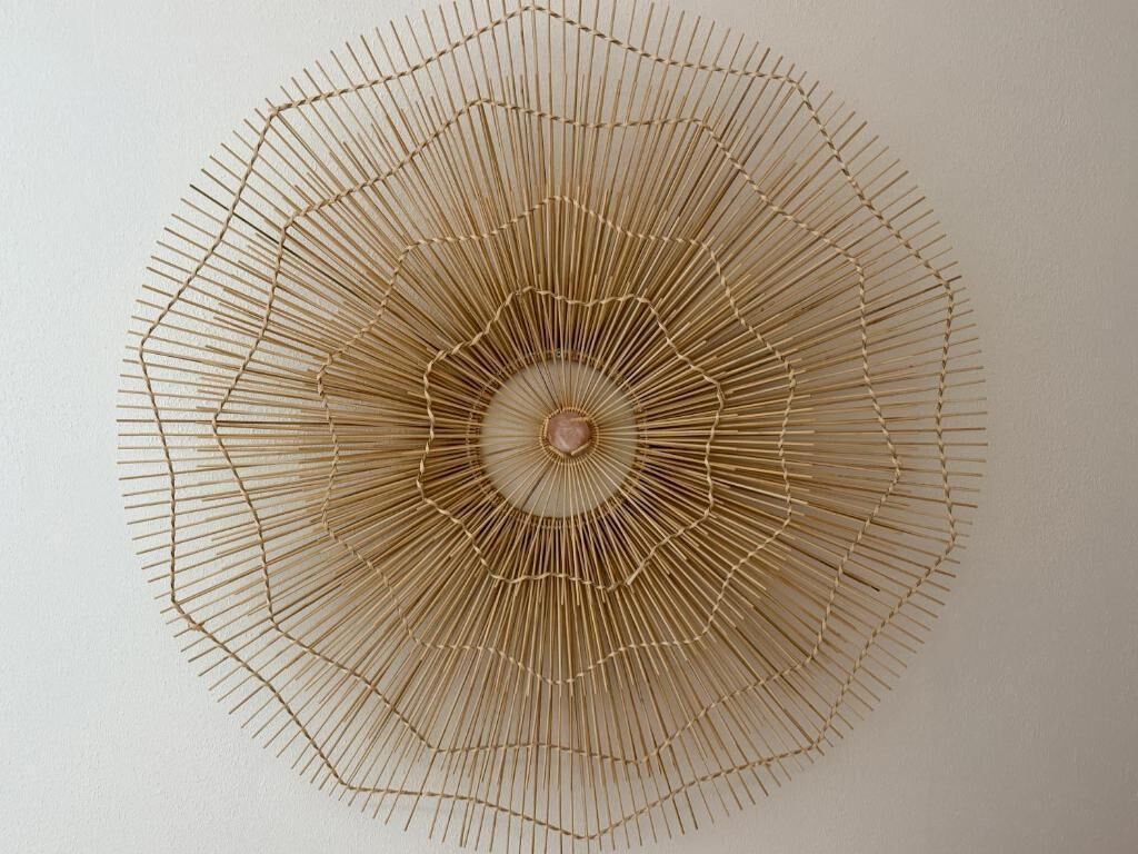 A circular, radiating structure with a central focal point, possibly a decorative element or artwork.