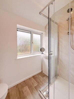 Shower, hair dryer, towels, toilet paper
