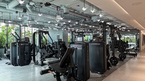 A modern gym with various exercise machines, large windows, and a clean, industrial design. - Canal View Studio Near Dubai Mall (Dubai)