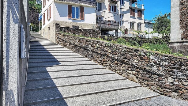 A stone staircase leading up to a building with multiple balconies. - Casa Yakamos by Interhome (Brissago)