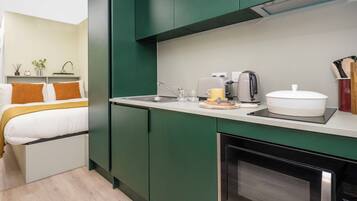 A compact kitchen with a microwave, toaster, and coffee maker.
