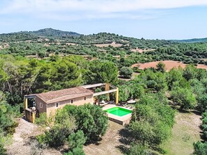 A villa with a swimming pool, surrounded by dense greenery and hills in the background. - Viterbo by Interhome (Son Servera)