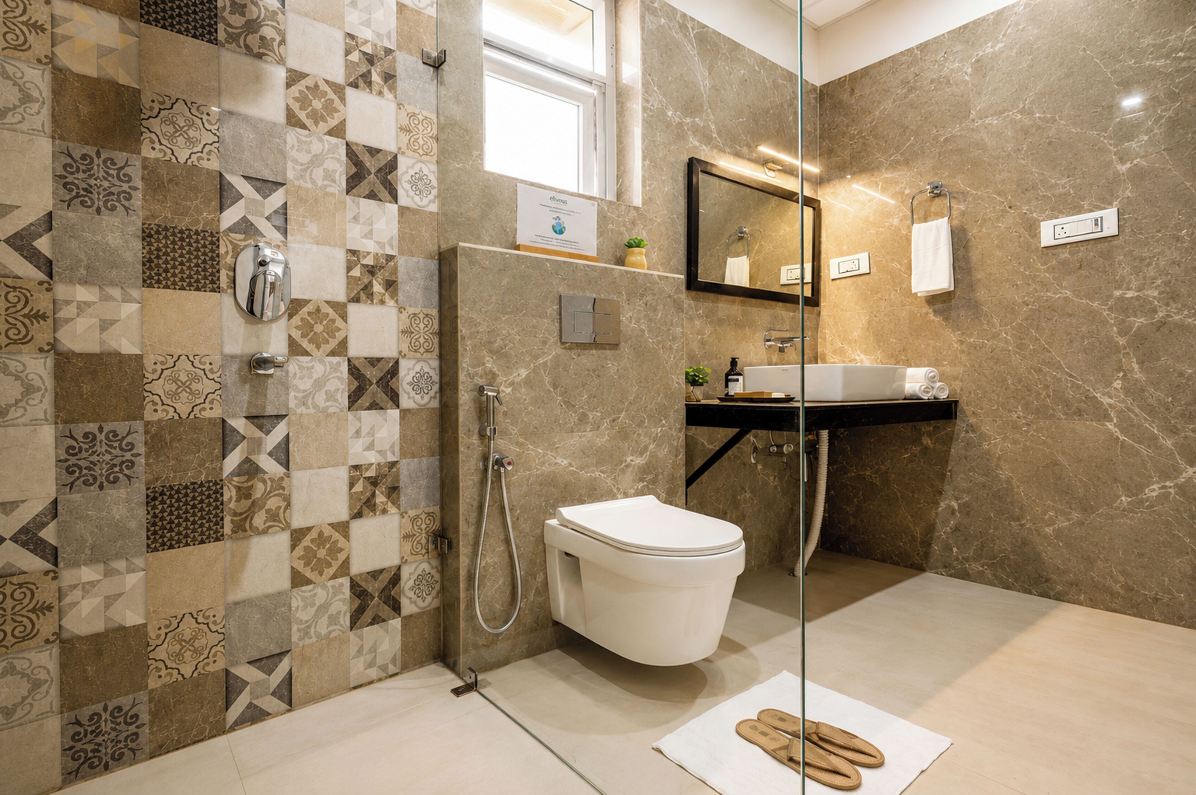 A bathroom with a tiled shower wall, a toilet, a sink, and a mirror.