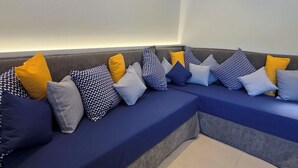 A sectional sofa with multiple cushions in a neutral color scheme. - Azure West by Cozy Corner (Ag. Georgios)