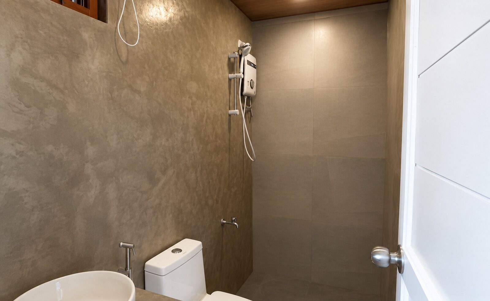 A bathroom with a shower, toilet, and sink.