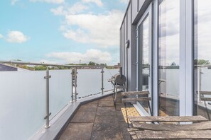 Eine Dachterrasse mit Blick auf den Himmel und entfernte Gebäude.