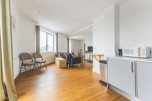 Ein modernes Apartment mit Küche, Essbereich und Wohnzimmer.