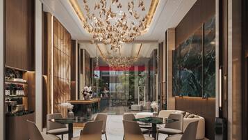 A modern interior with a dining area, seating, and a decorative chandelier.