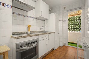 A kitchen with white cabinets, a stainless steel range, and a granite countertop. - Central Apartment 'Apto Anabel Nerja' (Nerja)