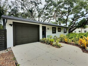 A single-story house with a garage, a front door, and a mailbox. - Garden Oasis Retreat — Your Private Sarasota Escape (Sarasota)