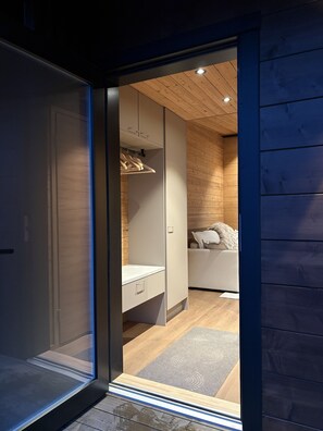 A modern interior with a sliding door leading to a bedroom.