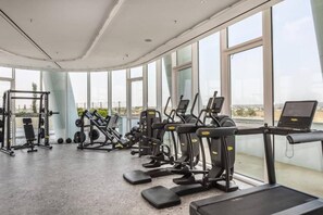 A gym with cardio machines, weightlifting equipment, and a treadmill. - Napa Horizon | Sea Front | Marina Tower 1702 (Ayia Napa)