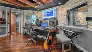 A music studio with a mixing console, computer, speakers, and a guitar. - Above Nashville West End Rhythm | Music Studio | Premium Location | Luxe (Nashville)