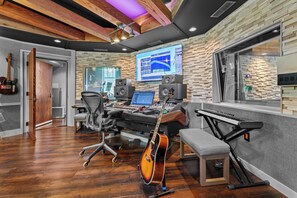 A music studio with a mixing console, computer, speakers, and a guitar. - Above Nashville West End Rhythm | Music Studio | Premium Location | Luxe (Nashville)
