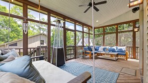 A covered outdoor living area with a sofa, a table, and a ceiling fan. - Above Nashville West End Rhythm | Music Studio | Premium Location | Luxe (Nashville)