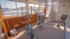 A fitness area with stationary bikes and a water bottle on the floor. - Sanssouci Star - Exclusive Island Cruise (Flensburg)