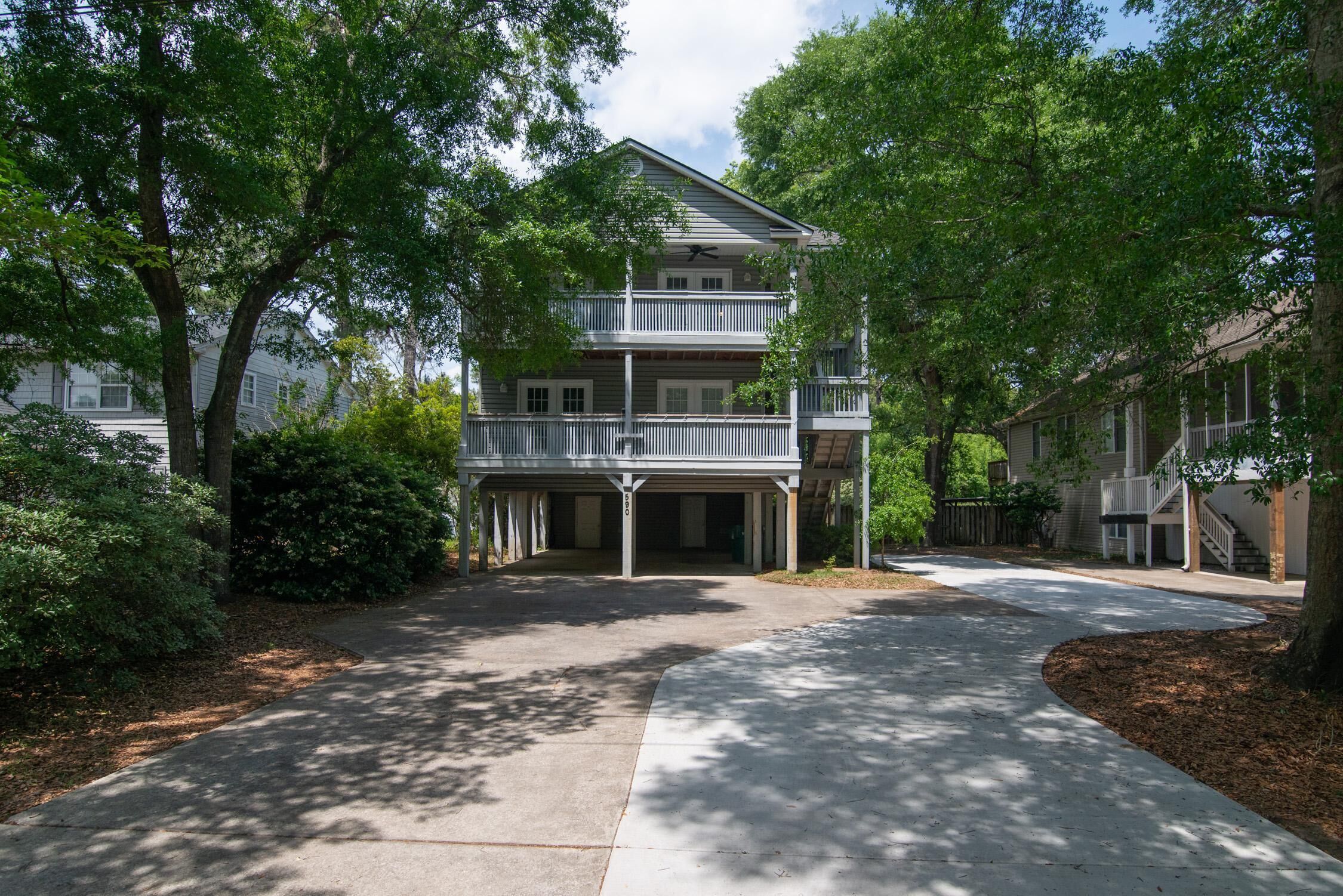 A two-story residential building with a covered front porch and a garage.