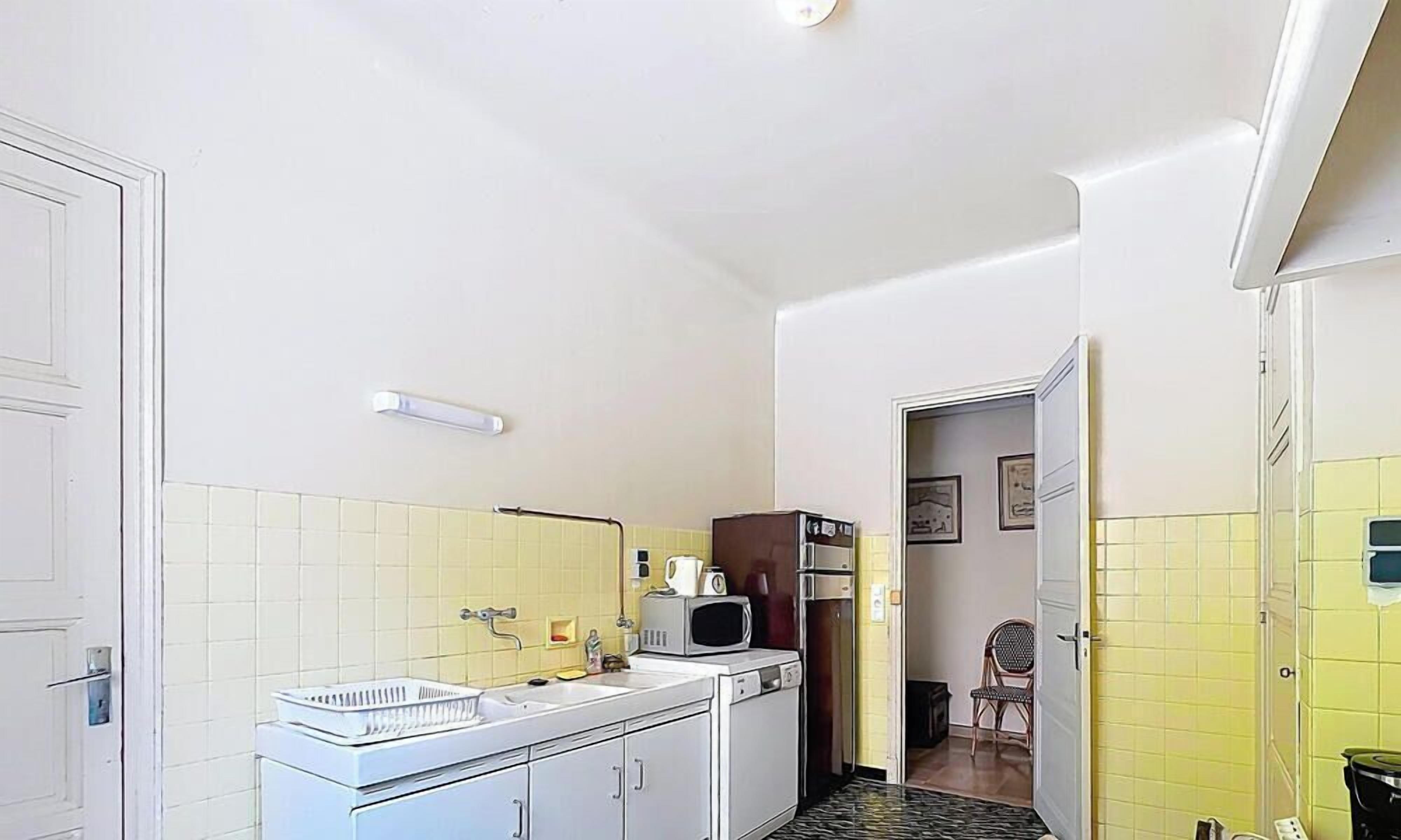 A compact kitchen with a sink, microwave, and refrigerator.