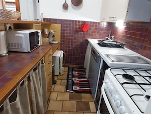Eine Küche mit Mikrowelle, Wasserkocher, Toaster und Herd.