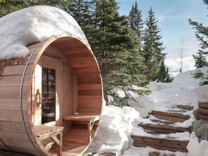 A wooden cabin with a semi-circular exterior and a visible interior seating area. - Chalet in Courchevel 1850, 8 guests, ski-in/ski-out, sauna, Wifi (Courchevel)