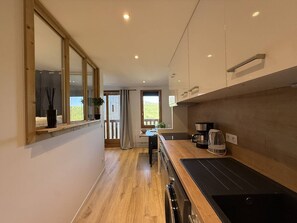 A modern kitchen with a wooden countertop, built-in oven, and a window overlooking a balcony. - Bright studio with unobstructed view - 4 guests (Belle Plagne)