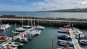 A marina with various boats docked at the pier.